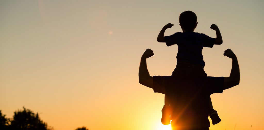 dad holding son on shoulders