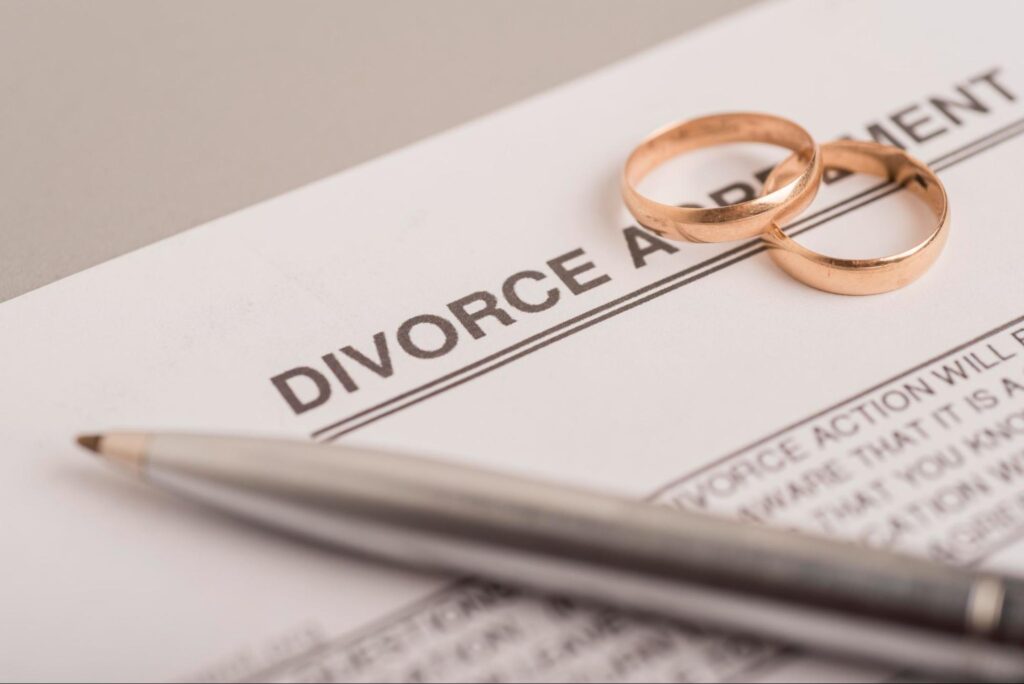 Pen and rings on divorce paperwork