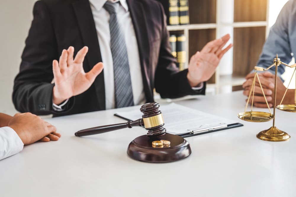 During the divorce proceedings, mediation involves a male lawyer counselor facilitating discussions between the husband and wife to reach an agreement, ultimately leading to the signing of the divorce contract.