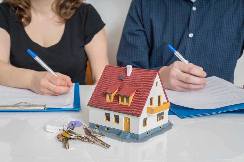 Divorce and property division concept: A couple signing a divorce agreement.