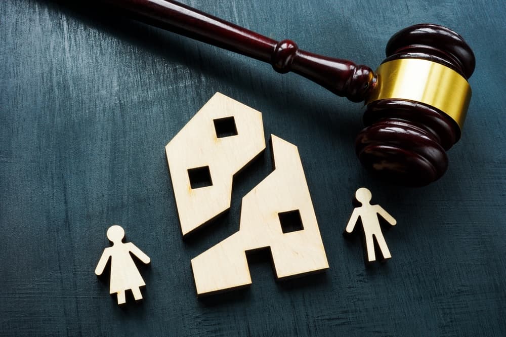 Property division in divorce: A house split between family members.