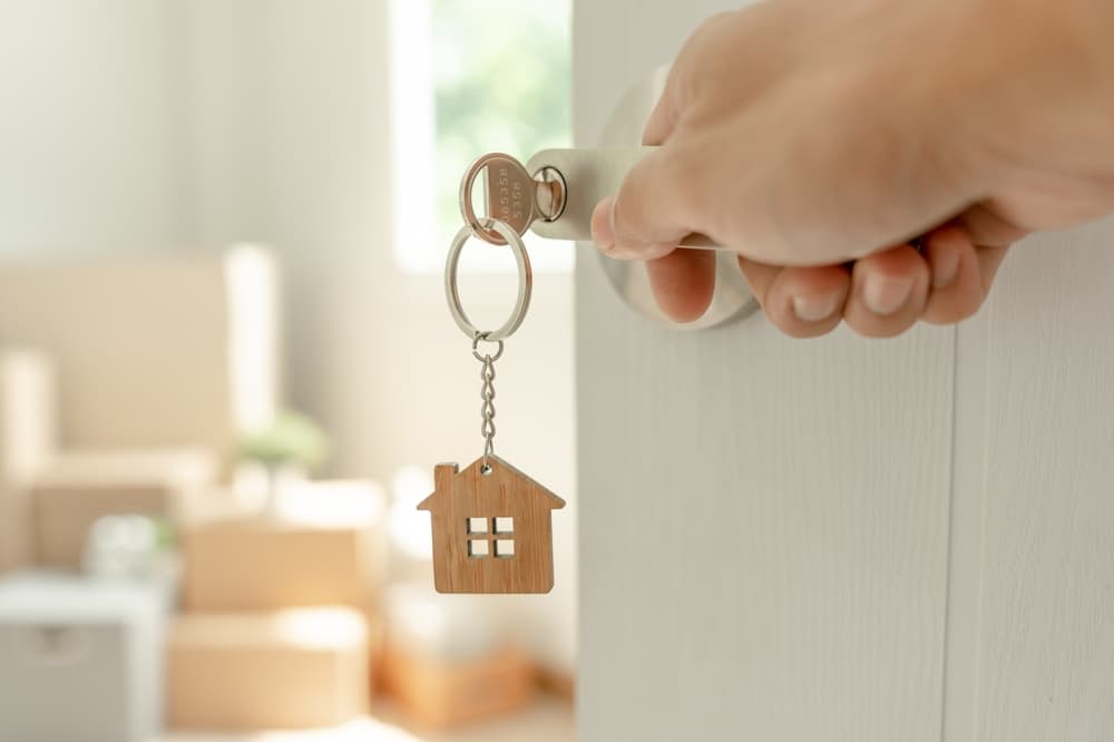 Moving house, relocation. Man open new room in new apartment, inside the room was a cardboard box containing personal belongings and furniture.