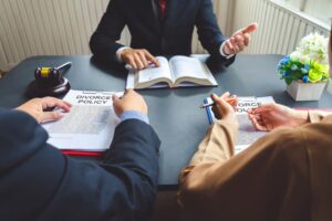 A couple consults a lawyer about finalizing their divorce agreement.