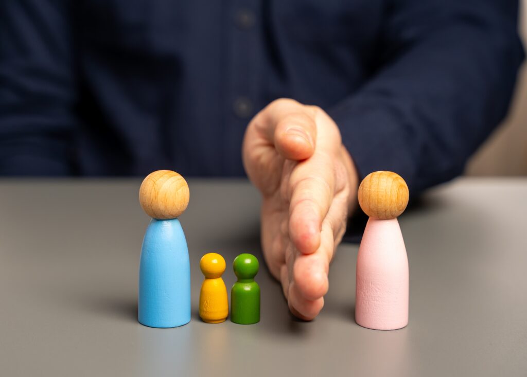 Parents agreeing on child relocation after divorce with symbolic figures separated by hand representing legal consent