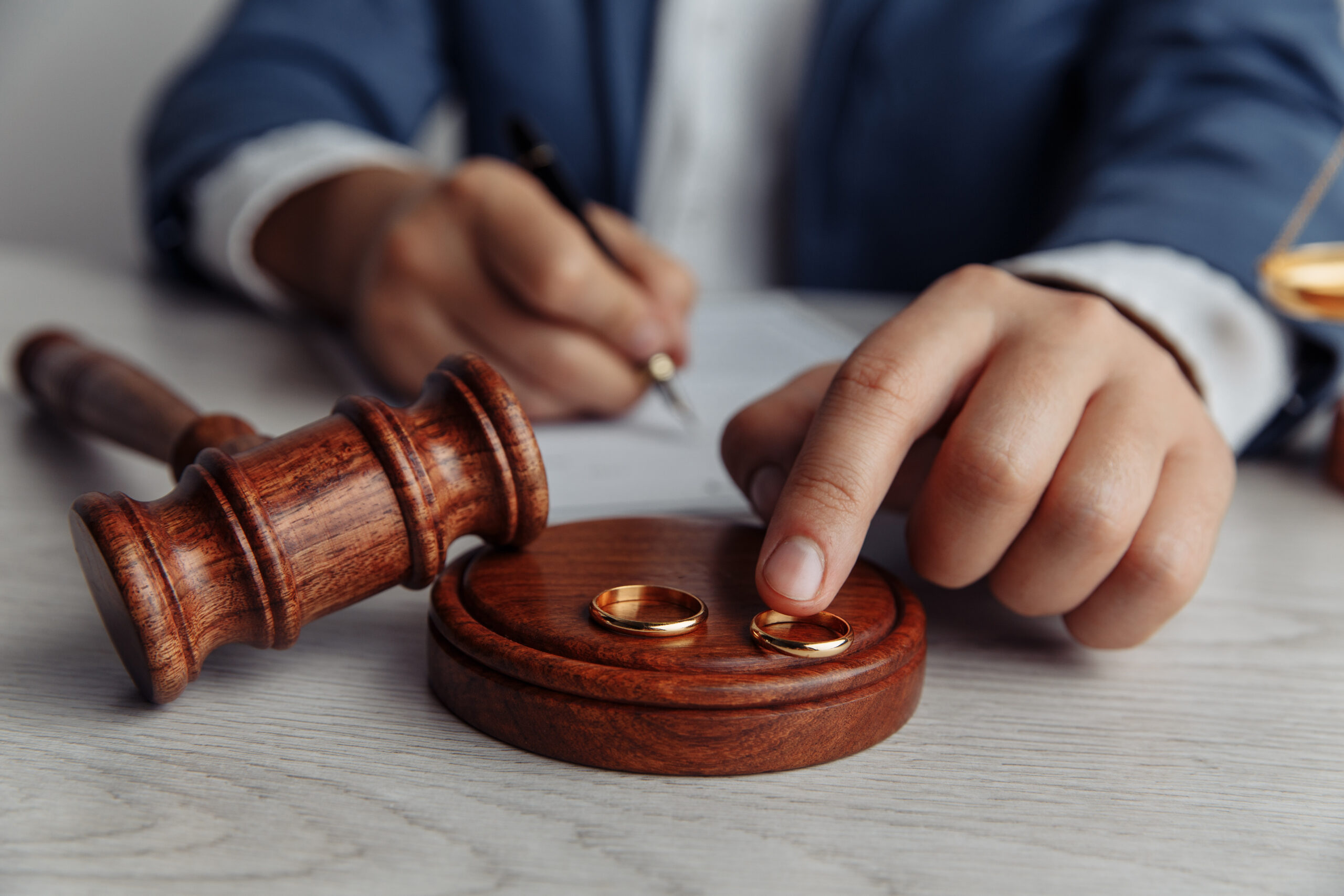 Attorney handling wedding rings and gavel symbolizing high asset divorce proceedings and legal representation in Scottsdale